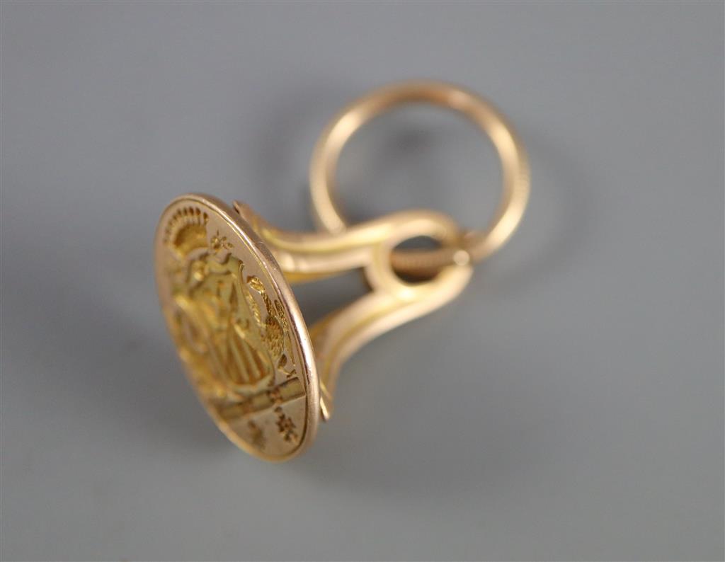 An early 19th century French 18ct gold fob seal, carved with ornate crest,